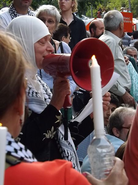 Palestinian woman reading some of the names of the Palestinians killed during the attack on Gaza - July 25