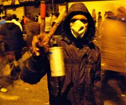 Tahrir Square protester with tear gas cannister shot by security forces and military police. Photo Credit: Ahmed Ghappour